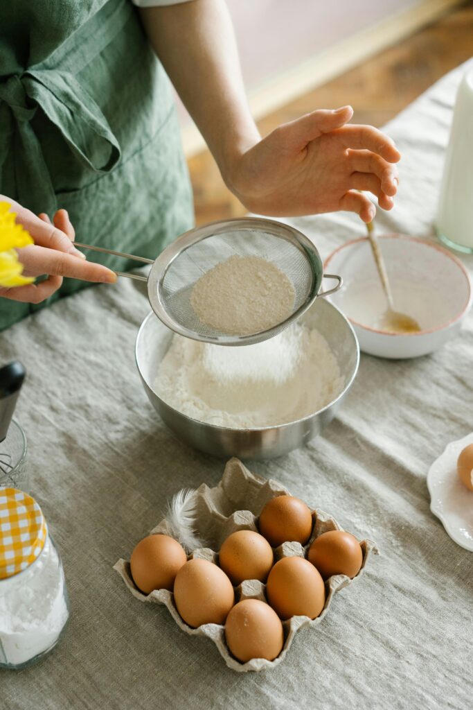 Professional baking tools and gadgets used for sifting flour in a home kitchen.